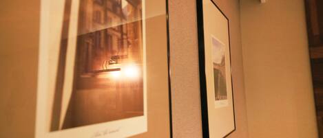Framed photographs on a wall, possibly in a hotel or similar establishment.