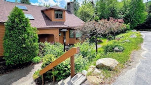 A brick house with a sloped roof, a chimney, and a small window. - FC17 Stylishly renovated Forest Cottage, walk to ski trails, wifi, cable, ping pong, AC! (Bretton Woods)