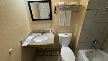 A bathroom with a sink, toilet, and bathtub.