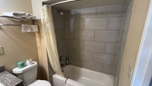 A bathroom with a toilet, sink, and bathtub. - Country Inn-Giddings (Giddings)