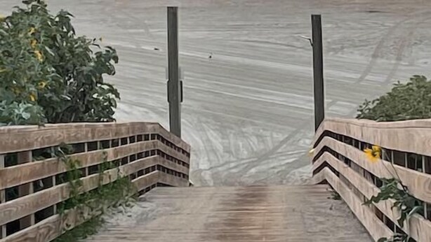 A wooden boardwalk leading to a beach with a sunset in the background. - Shared Pool and Hot Tub, Golf Cart Included, Beach Boardwalk, Pet Friendly (Port Aransas)