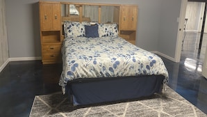 A bedroom with a bed, wooden headboard, and built-in drawers. - private 6 Bedroom charming  2000 sq ft ranch 10-14 people (Sterling Heights)