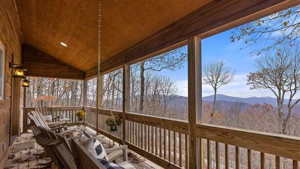 A wooden deck with a bench and hanging chairs, overlooking a mountainous landscape. - Cabin with Appalachian Mountain Views (Boone)
