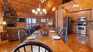 A spacious cabin interior with a dining area, kitchen, and living room. - Cabin with Appalachian Mountain Views (Boone)