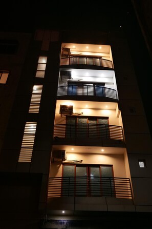 A multi-story building with balconies and windows.