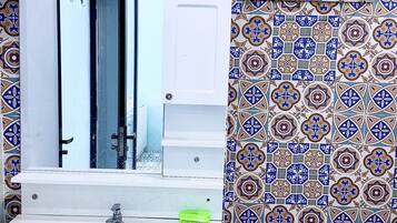 Combined shower/bathtub, hair dryer, soap, toilet paper