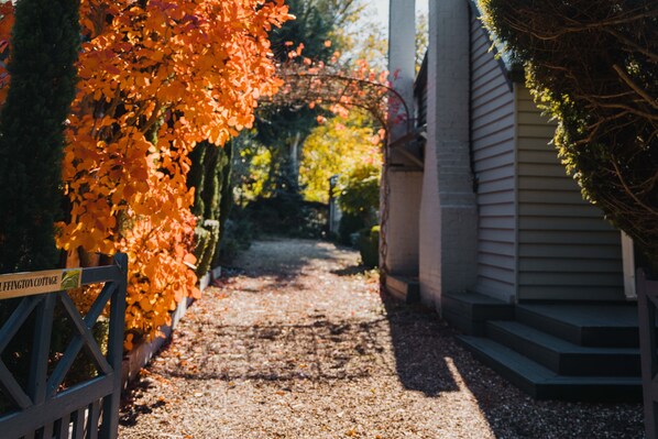 A pathway leading to a house with a sign reading "Luffington Cottage."