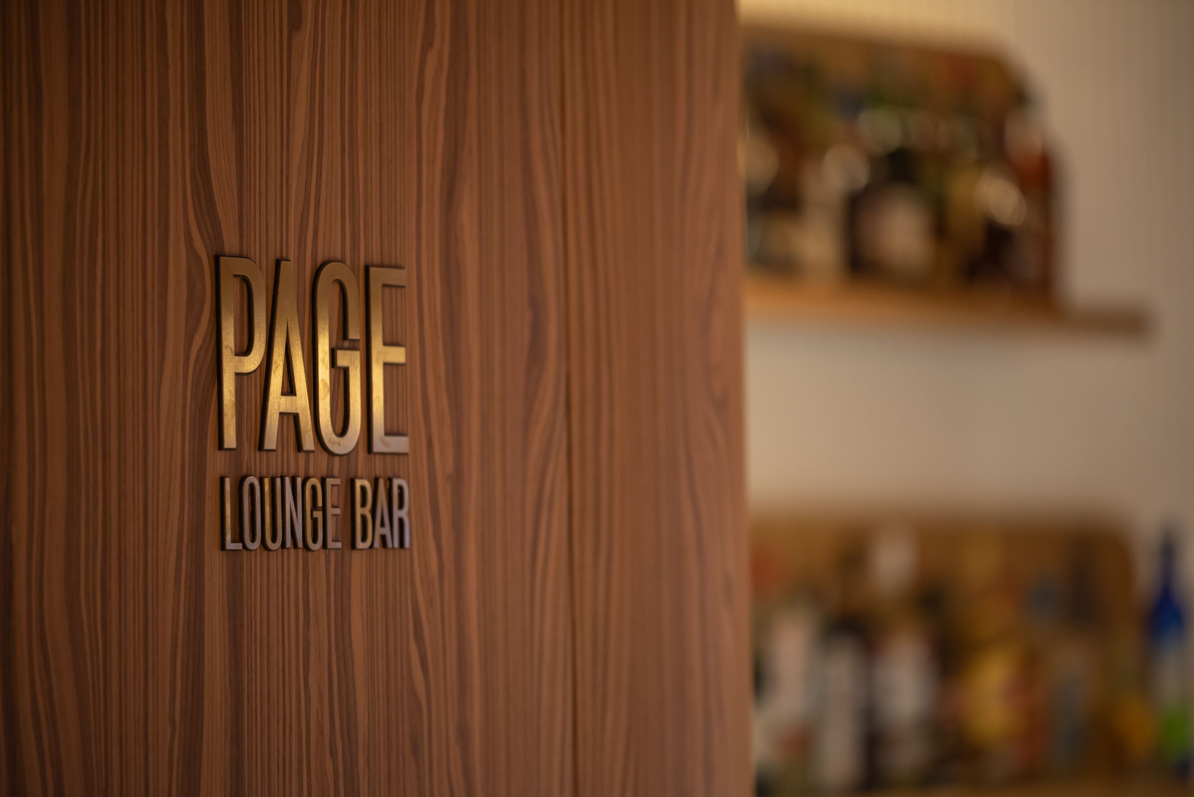 A wooden wall with the text "PAGE LOUNGE BAR" indicating a lounge area.