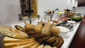 Een buffet met verschillende soorten brood en een saladebar.