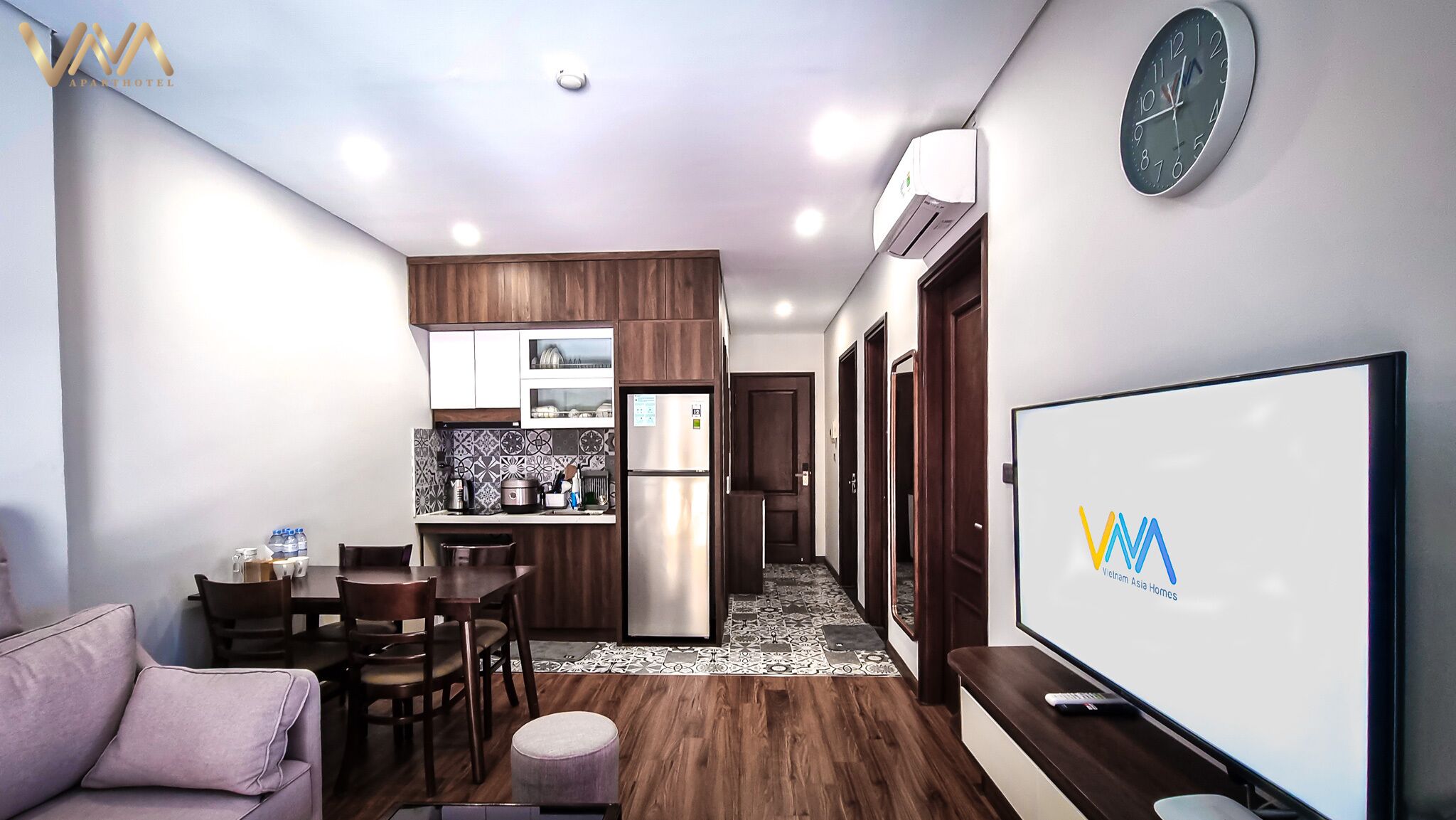 A modern apartment with a kitchen, dining area, and living room.