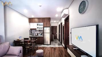 A modern apartment with a kitchen, dining area, and living room.