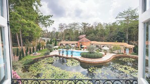 A courtyard with a swimming pool, a fountain, and a gazebo.