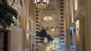 A spacious lobby with a reflective marble floor, large decorative columns, and ornate chandeliers. - Jumeirah Zabeel Saray Royal Residence Lagoon Villa (Dubai)
