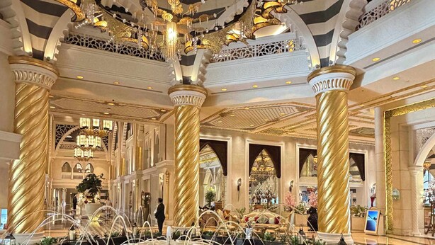 A luxurious lobby with a grand chandelier, ornate columns, and a central fountain. - Jumeirah Zabeel Saray Royal Residence Lagoon Villa (Dubai)