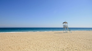 A beach with a lifeguard tower.