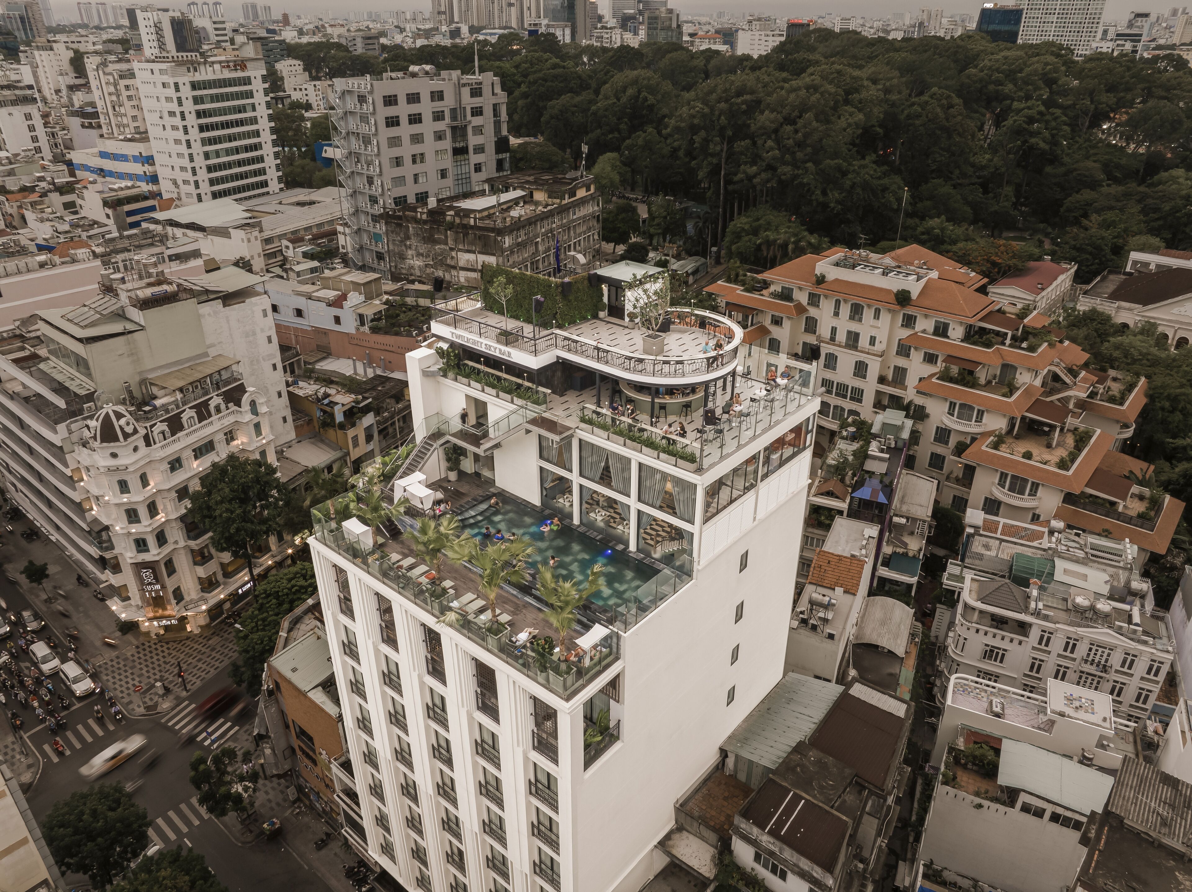 A high-rise building with a rooftop pool and a bar named "Twilight Sky Bar".
