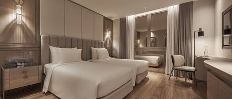 A modern hotel room with a large bed, bedside tables, a desk, and a chair.