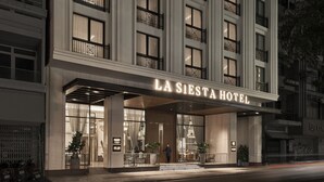 A hotel entrance with a large illuminated sign reading "LA SIESTA HOTEL". - La Siesta Premium Saigon (Ho Chi Minh City)
