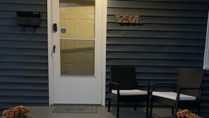 A house with a white door, number 2501, two chairs on the porch, and potted plants. - Be our guest BOHO 2.0 (Charlotte)