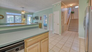 A kitchen with a built-in dishwasher, a wooden countertop, and a view of the living area. - Piper's Retreat - Four Bedroom, Three Bath Dog Friendly Home (Surfside Beach)