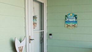 Uma porta com uma placa que diz 'WELCOME', o número '207' e uma placa 'NARVIDS PARADISE' na parede.