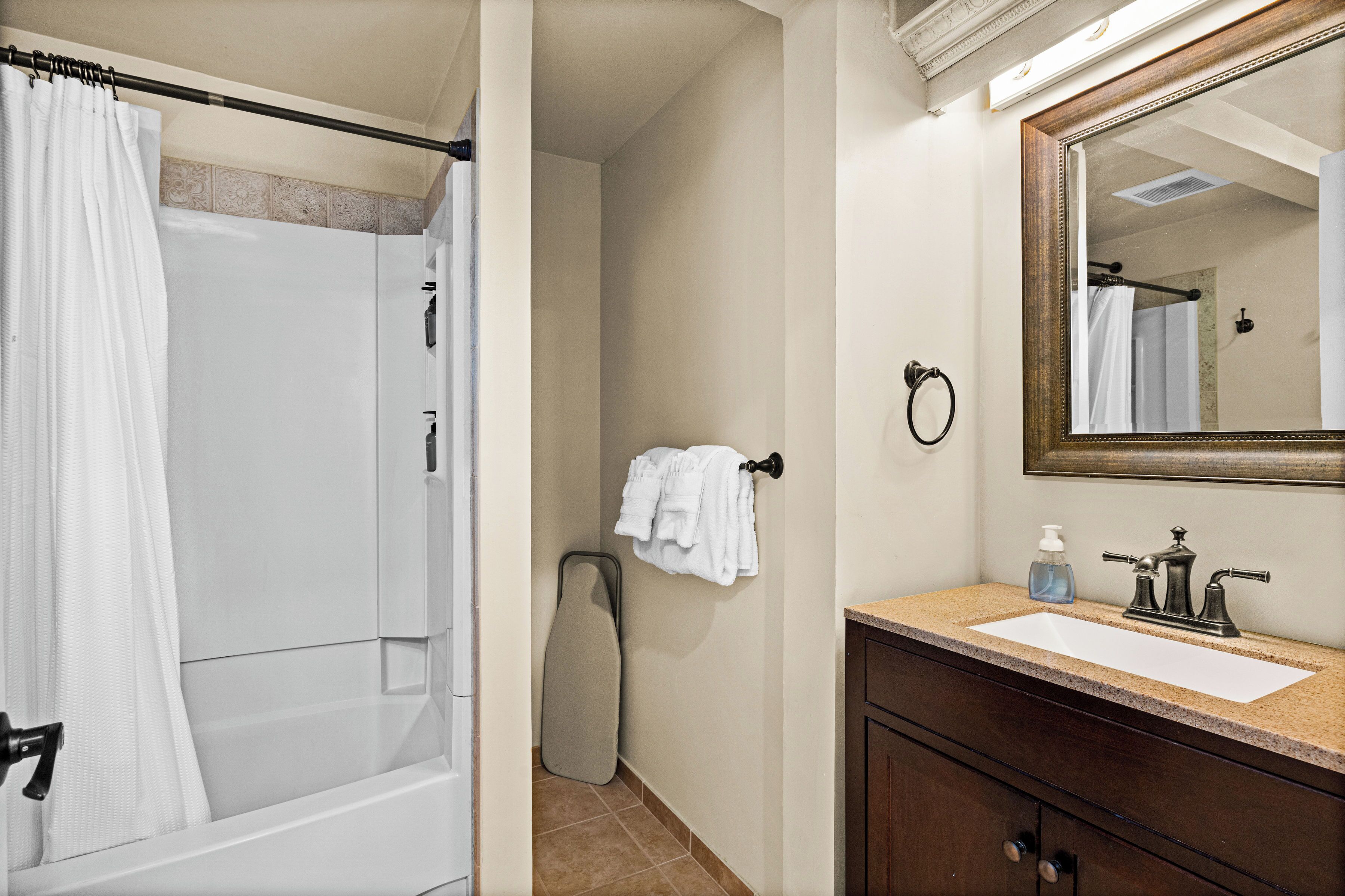 Une salle de bain avec une douche, un lavabo et un miroir.