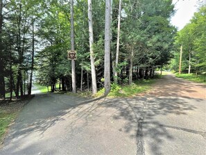 A paved road with a sign indicating a campground. - Thunderhead_Lodge_Mainhouse (Butternut)