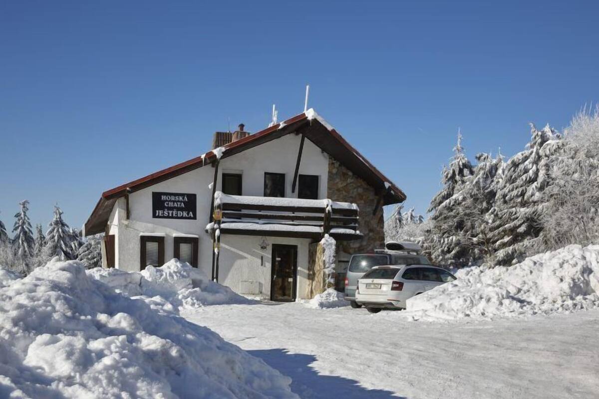 Un edificio con un cartello che riporta la scritta "Horská Chata Jestědka".