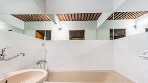 A bathroom with a sink, bathtub, and mirrored walls. - Chata Ještědka (Svetla pod Jestedem)