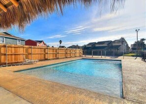 A rectangular swimming pool with a wooden fence and a concrete deck. - Near Beach, Pool & Pet Friendly - Lemon Chill (Port Aransas)