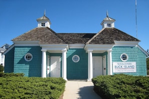 A two-story building with a sign reading "Welcome Buck Island".