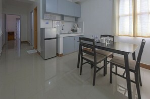 Family Suite | Private kitchen | Full-size fridge, microwave, electric kettle, dining tables