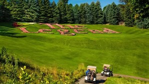 A golf course with a large 'The Legend' text made of flowers. - The Ope! North Hideaway (Bellaire)