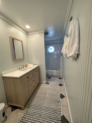 Combined shower/bathtub, towels, soap, toilet paper
