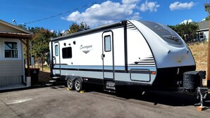 A recreational vehicle parked in a driveway with a house in the background. - Classic Charm Close To Lake (Canyon Lake)