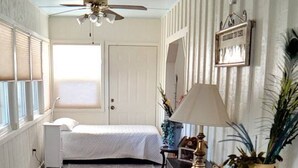 A narrow hallway with a bed, a desk, a lamp, and a potted plant. - Classic Charm Close To Lake (Canyon Lake)
