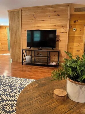 Relax in this stylish living room with a flat-screen TV, coffee table, and comfortable seating area.
