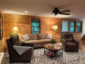Relax in this inviting living room with a leather sofa, armchairs, and a coffee table.