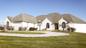 A two-story house with a symmetrical design, a central entrance, and a well-maintained lawn. - Holland Estate (Williamstown)
