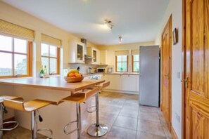 Enjoy cooking in this well-equipped kitchen with a central island and ample natural light.