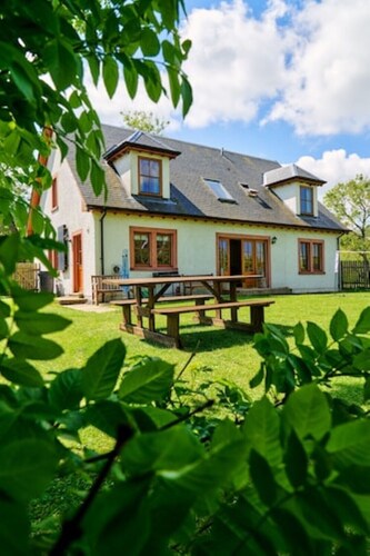Country farmhouse sleeps 9 with enclosed garden and games barn.