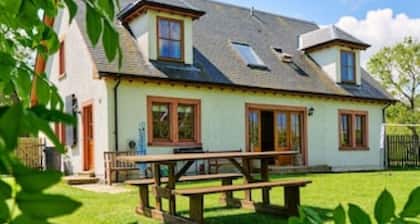 Country farmhouse sleeps 9 with enclosed garden and games barn.