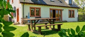 Country farmhouse sleeps 9 with enclosed garden and games barn.