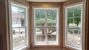 A corner room with three large windows, a wooden floor, and a recessed ceiling light. - Enjoy 3 King beds with ensuite baths, 8 total beds (Fayetteville)