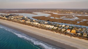 An aerial view of a coastal town with beachfront properties, a river, and a beach. - Palmettos & Sunshine: Oceanfront w/ Pool, Hot Tub, & Stunning Views (Garden City Beach)