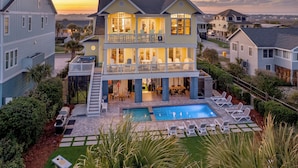A large two-story house with a swimming pool and outdoor seating area. - Palmettos & Sunshine: Oceanfront w/ Pool, Hot Tub, & Stunning Views (Garden City Beach)