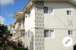 Stunning multi-story building with balconies and a decorative facade featuring geometric patterns.