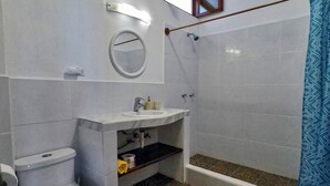 A bathroom with a toilet, sink, and shower. - Galeodan Dorado Suite - Spacious Family Suite with Gorgeous Ocean View (Puerto Baquerizo Moreno)