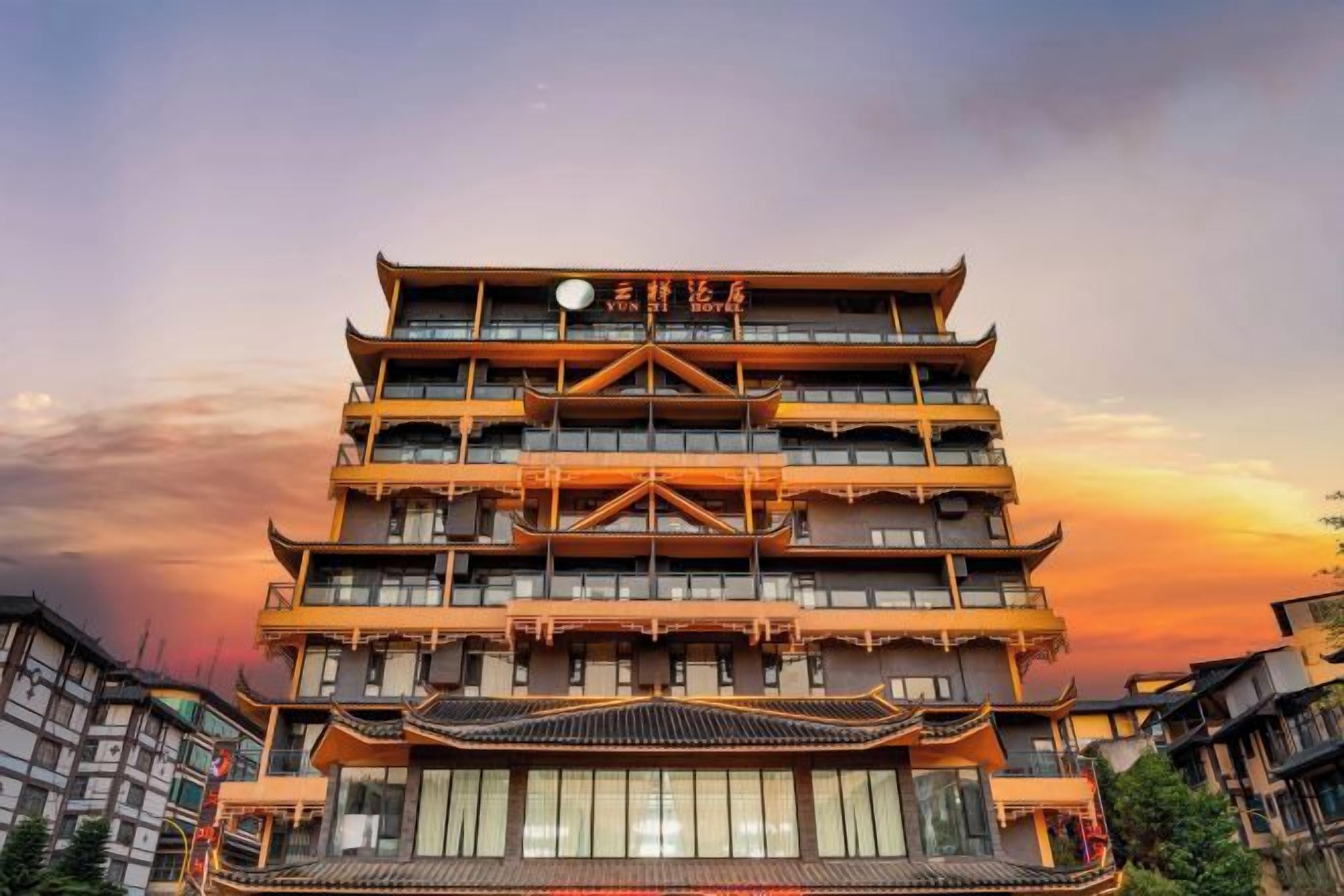 A multi-story building with traditional architectural design, featuring balconies and a central entrance.
