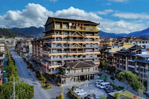 A multi-story building with a traditional architectural style, featuring balconies and a central courtyard.